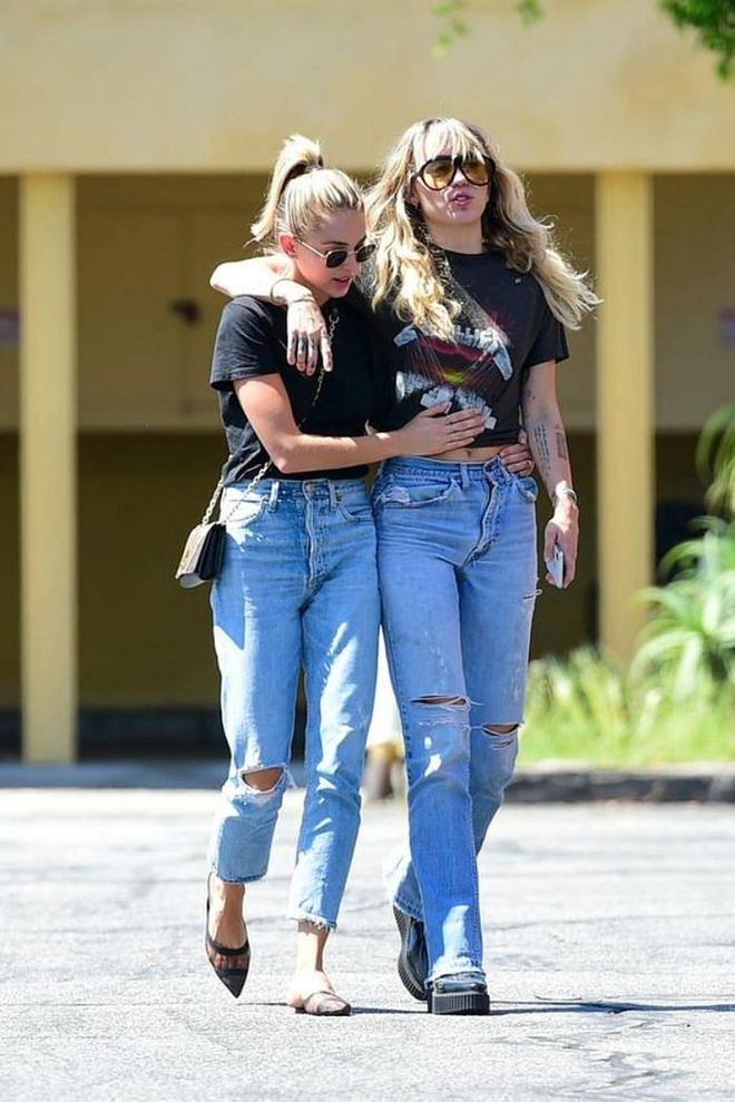 Miley out with Kaitlynn Carter in matching girlfriend jeans and band tees.

Photo: Getty