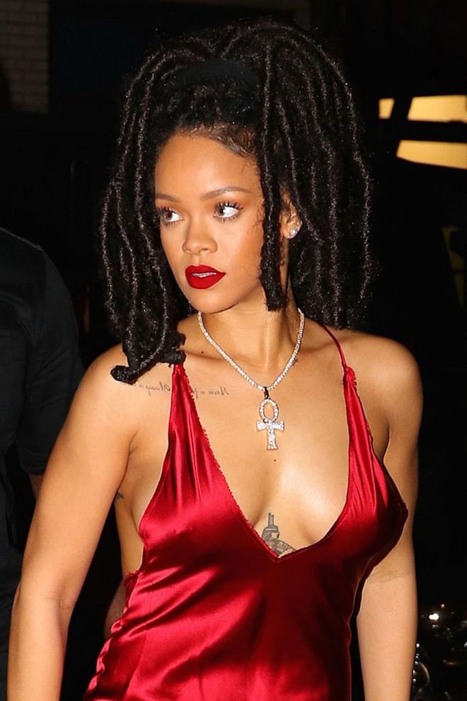 Rihanna owns the color red with her silky dress and matching lips.