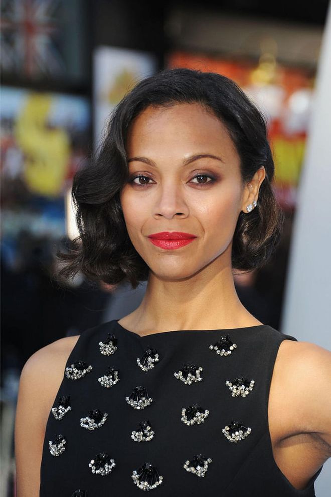 Saldana takes a vacation from her signature long locks with an elegant asymmetrical cut and a red lip. 