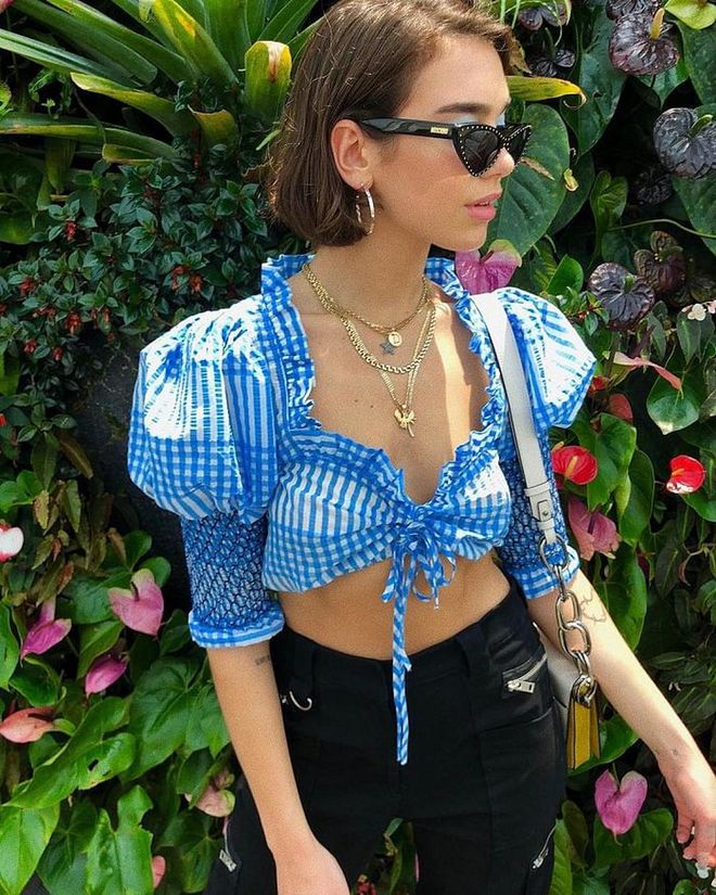 While in Singapore for her solo concert earlier in May, Dua wore this plaid Ganni crop top with I.AM.GIA pants out for some sight-seeing at Gardens By The Bay. The Moschino sunglasses, Marni caddy bag and her signature Shami necklaces add on some edge to her girly top.
Photo: Instagram