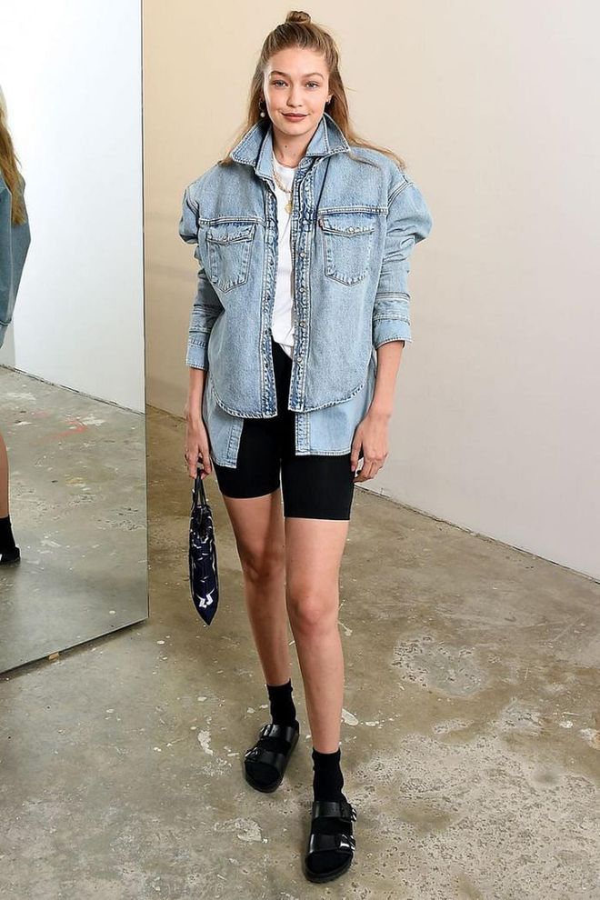 Gigi wore socks with Valentino birkenstocks to WARDROBE.NYC's launch of Release 04 DENIM & Levi's® Collaboration in NYC. She paired the look with denim layers, biker shorts and gold necklaces.