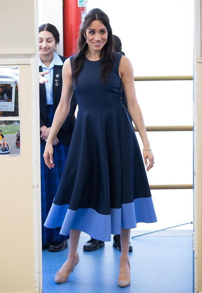 The Duchess changed into a navy Roksanda 'Athena' pleated two-tone crepe midi dress and nude Stuart Weitzman pumps for a youth advocate programme at a high school. 
