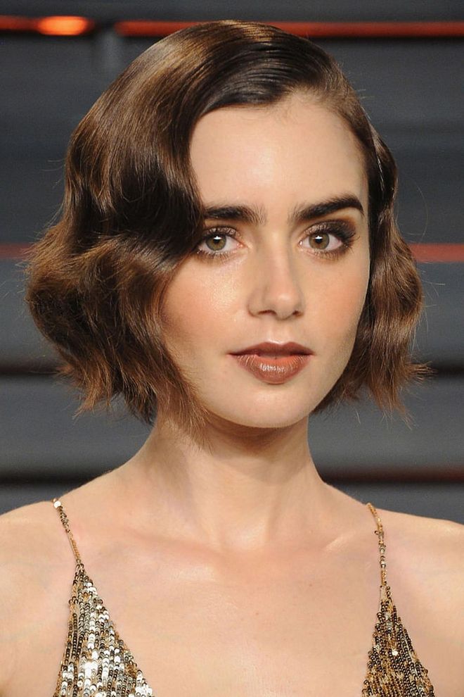 S-wave curls add texture and definition to Lily Collins' brief bob.