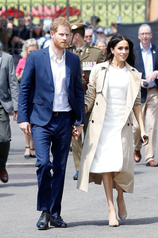 Meghan kicked off the Australian Royal Tour in a pristine white Karen Gee dress and a light tan trench. The Duchess aptly sported an Australian designer for Day 1 and accessorized with nude Stuart Weitzman pumps and Princess Diana's butterfly earrings. 