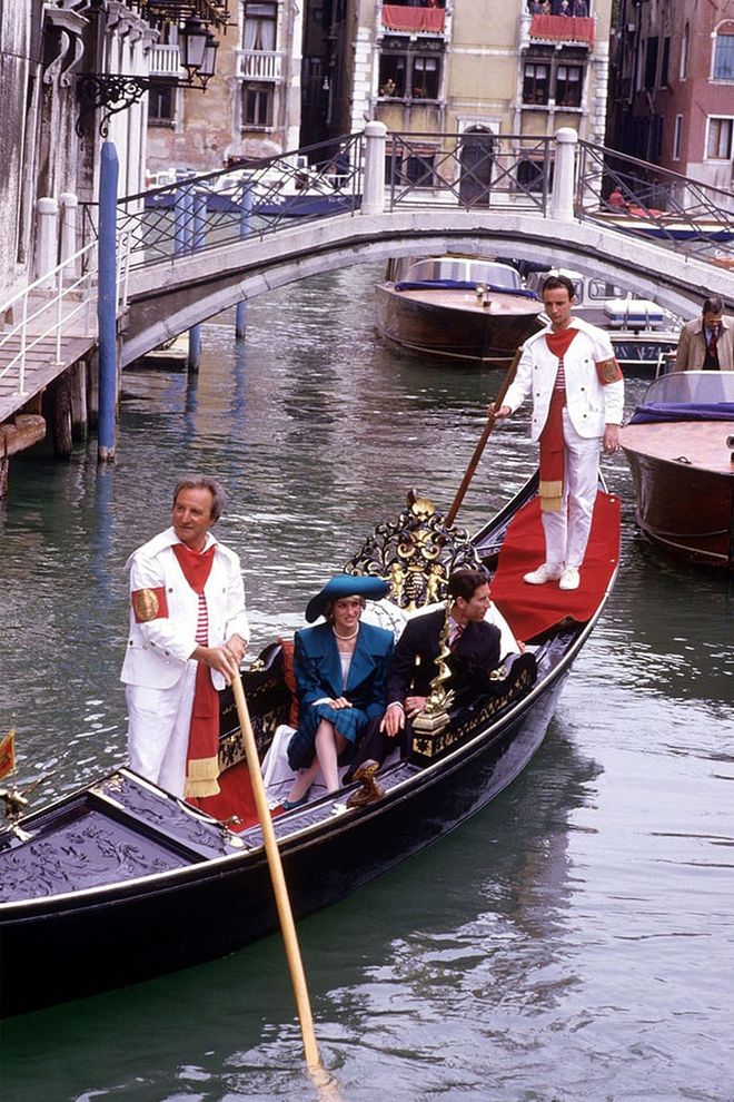 In a blue jacket and hat while riding in a gondola with Prince Charles in Venice. Photo: Getty