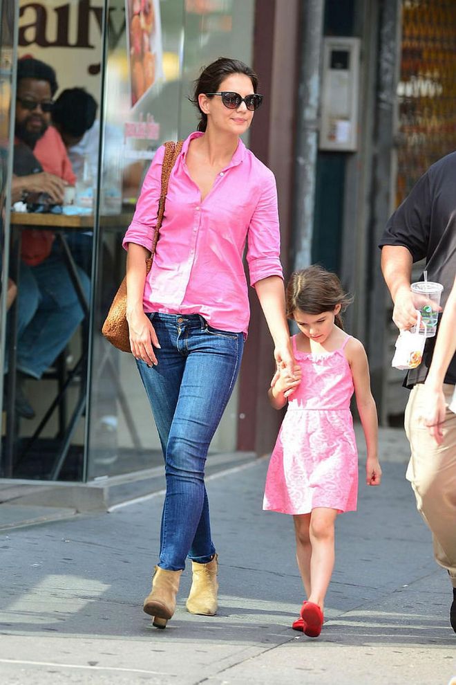 Stepping out in another twinning look, Katie Holmes and daughter Suri Cruise wore coordinating bright pink for a sweet mother-daughter style moment. While Katie opted for a pink button-down shirt and jeans, her daughter went for a more playful look in a pink ruffled dress and sandals. Photo: Getty