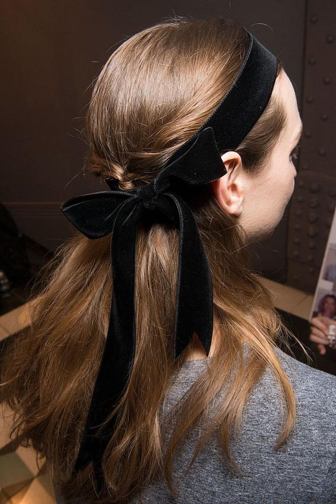  At Temperley London, velvet hair bows complemented small black ribbons tied delicately around the neck.