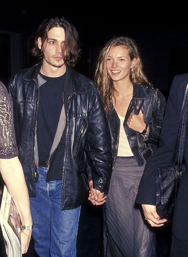 The most iconic couple of the 90s walk hand-in-hand clad in matching leather jackets in 1994. Photo: Getty 