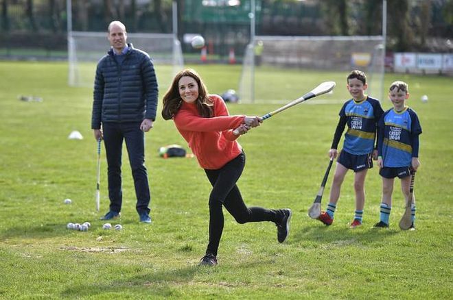 Kate tries her hand at another sport as two boys and William watch her in the background.

Photo: Getty