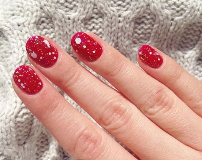 Make over a scarlet manicure with a festive glitter top coat. @chelseaqueen