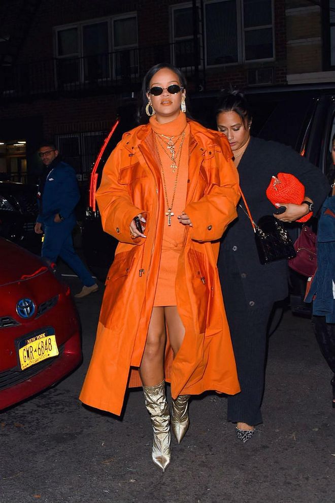Rihanna attended the Fenty pop-up shop at Bergdorfs in a burnt orange parka, a knit minidress, and champagne-coloured boots. She finished off the look with jewellery from Chrome Hearts, Melissa Kaye, David Webb, Sue Gragg, and Rafaello and Co.