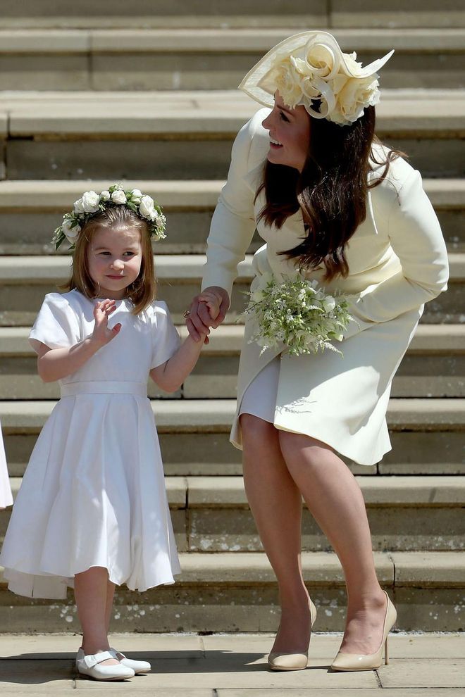 Duchess Kate leaves the royal wedding of the Duke and Duchess of Sussex just four weeks after giving birth to Prince Louis. Here, she's seen talking to flower girl Charlotte on the steps of St. George's Chapel at Windsor Castle.
Photo: Getty