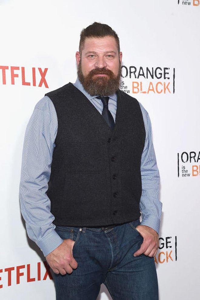 This former NFL player stands at 6-foot-4-inches tall, but he's far less intimidating IRL than in his role on OITNB. Just look at his adorable sweater vest!