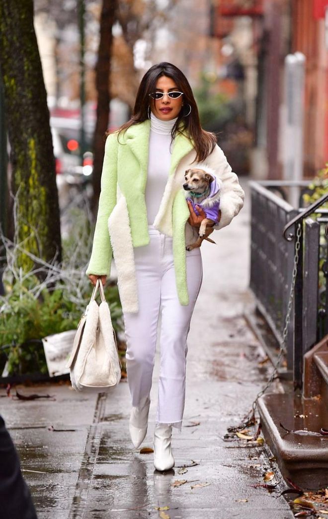 While walking (or carrying) her dog in New York, the actress stepped out in a neon green shearling jacket layered over an all-white look.

Photo: Getty