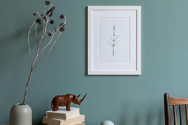 Minimalistic composition of sitting room interior with white mock up picture frame. Design home decor. Template. Eucalyptus color concept.