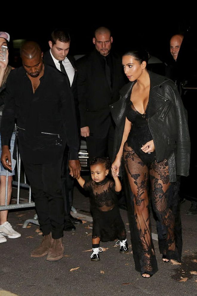North arrives at Givenchy's Spring 2015 show wearing a custom Givenchy by Riccardo Tisci look and lace-up combat boots alongside Kim Kardashian and Kanye West.