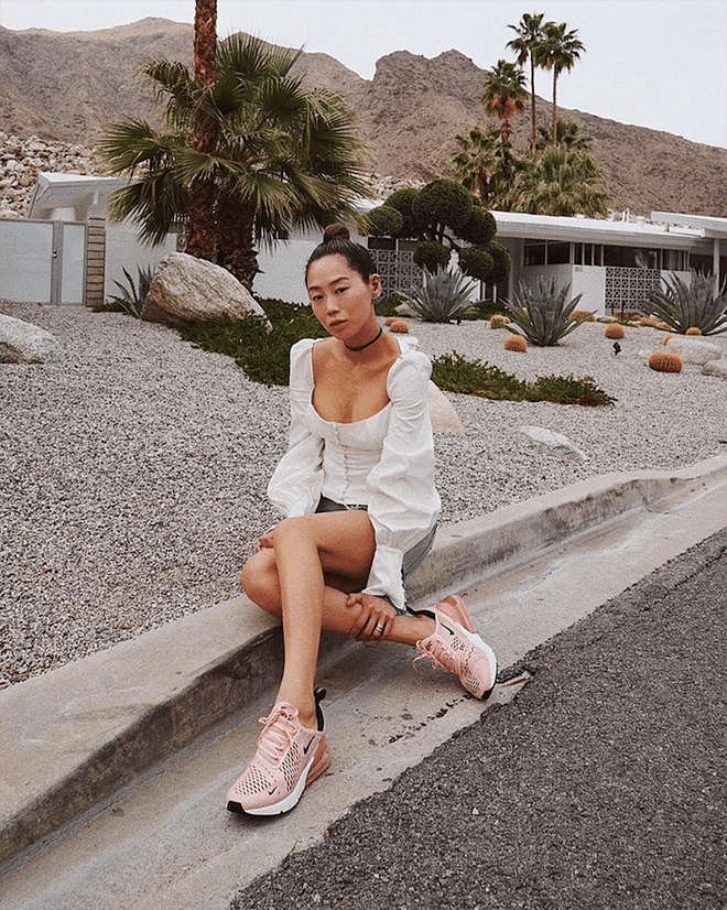Proving the reigning white top of Instagram has legs on the festival circuit is celeb influencer Aimee Song. She pairs hers with pink kicks for added fun.

Shop it: Capulet top, $88, revolve.com.