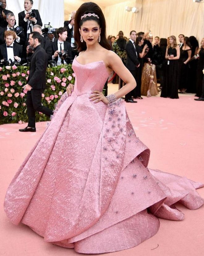 Padukone wore a show-stopping look to the 2019 Met Gala, where the theme was Camp: Notes on Fashion. Her structured, Barbie-pink gown was designed by Zac Posen and she wore her hair in a high beehive style, with a pink headband to match.

Photo: Theo Wargo / Getty