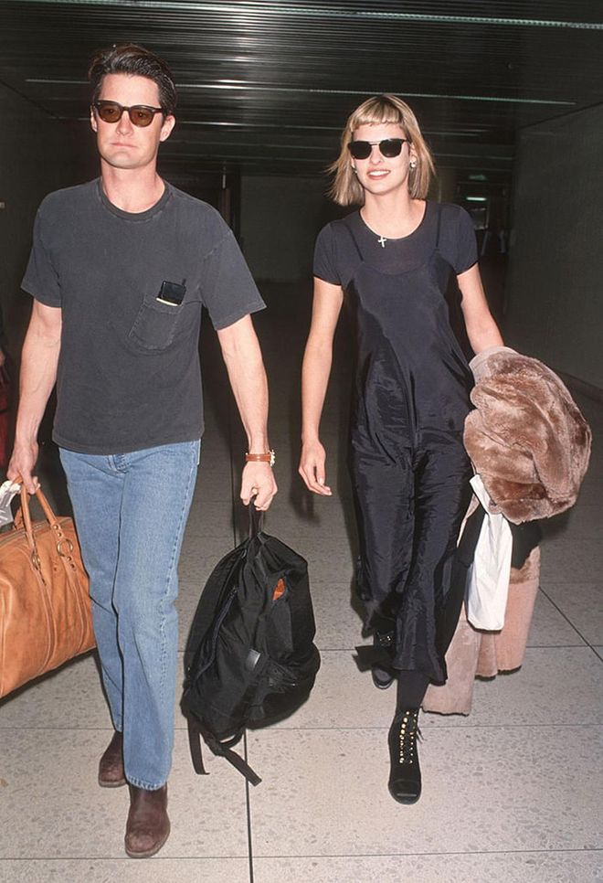 Evangelista pairs the black staple over a simple tee for an effortless airport look, at LAX in 1994. Photo: Getty