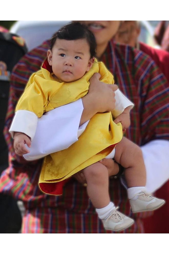 The future king of Bhutan looked too adorable in a yellow robe and white socks! 