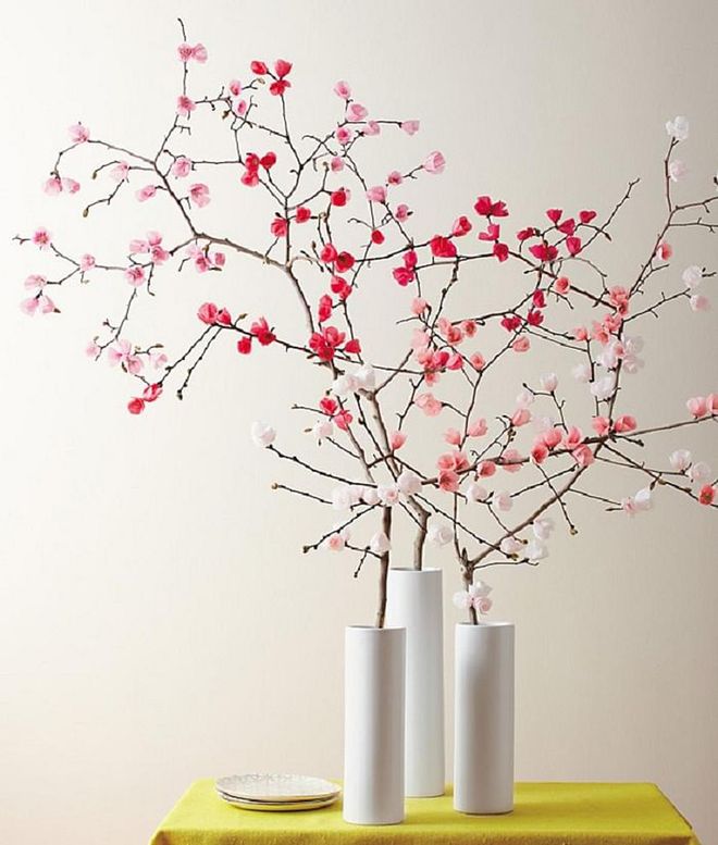 Along with the paper lanterns, you can also opt for paper flowers to add colour to your living space. There are several tutorials for DIY versions of paper flowers, so if you are itching to get crafty, now's the time. Pair the pink and red flowers with a white cylindrical vase and wait to be showered by compliments for your handy work. 