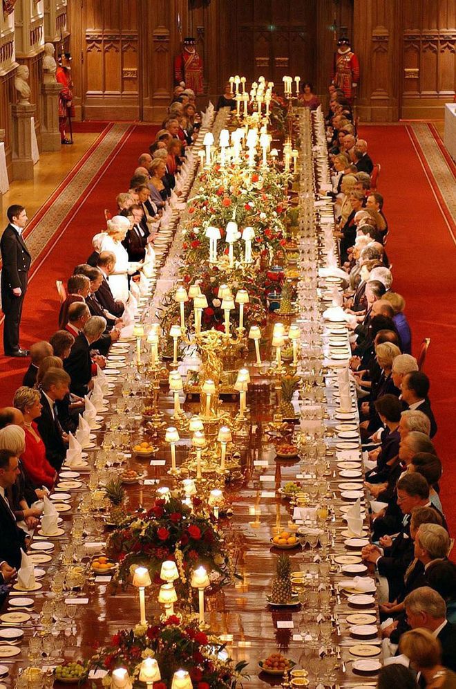 Seating at a royal dinner party is planned to a tee, and the Queen subtly schedules her conversations with the guests at her side—she spends her time speaking to the person on her right for the first course, and then engages in conversation with the guest on her left for the second.

Also, if royals need to step away from the table before they've finished their meal, it's expected that they cross their utensils, so that the staff doesn't remove their plate. If they're finished, the utensils are placed side by side at an angle with the handles facing the bottom right of the plate.
Photo: Getty