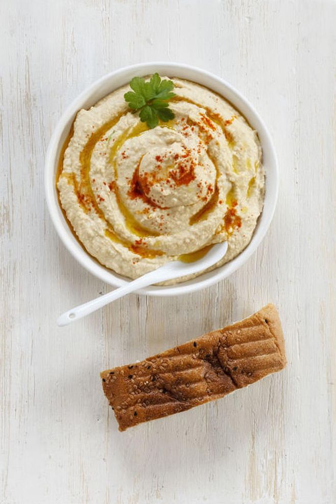 The chickpeas in hummus are a valuable source of trytophan and b6, the vitamin that helps you produce the sleep hormone melatonin. If you're looking for a healthier, low-calorie midnight snack, try a slice of whole-grain bread with hummus or a little bit of hummus with crackers. 