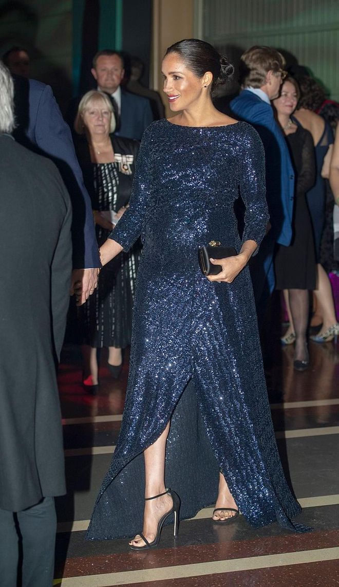 The Duchess sparkled in a navy, sequined gown by Roland Mouret at the London premiere of Cirque du Soleil’s 'Totem' last night. She accessorized simply with her black satin Givenchy clutch and Princess Diana's gold cuff bracelet. 