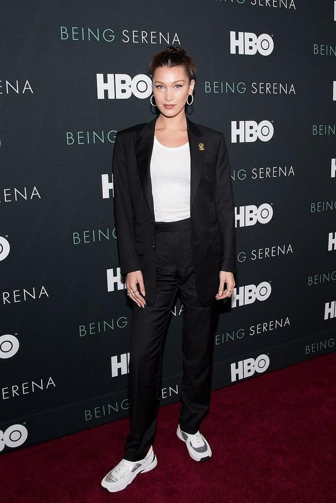 Attending a premiere in a black, boyfriend-style suit by Tom Ford and Chanel sneakers. 