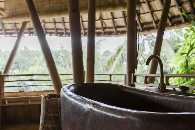This three-bed house is made entirely of bamboo and is set on the sacred Ayung river valley, just outside of the cultural city of Ubud in Bali. The house is nestled high up among the trees and features a copper bathtub which you can get in and look out onto the wildlife.