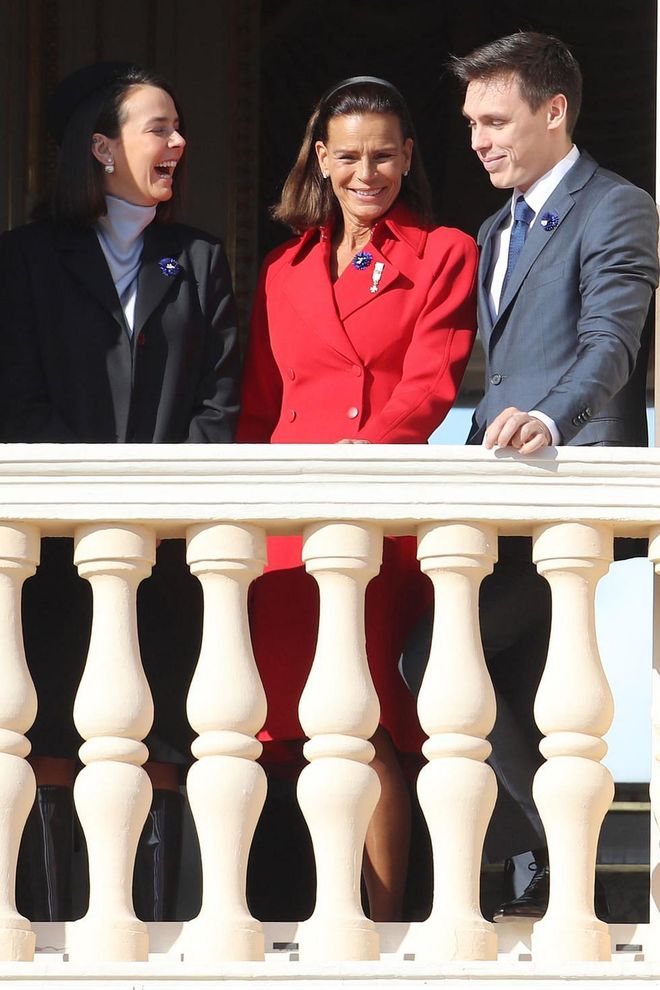 Princess Stephanie, on the balcony with her children Pauline and Louis, opted to wear a bright red coat, heels, and a simple black headband for the celebration.

Photo: Getty