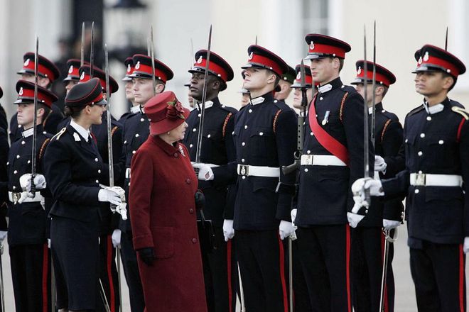 The Queen smiles at her grandson Prince William as she inspects soldiers at the passing-out Sovereign's Parade at Sandhurst Military Academy, December 2006.