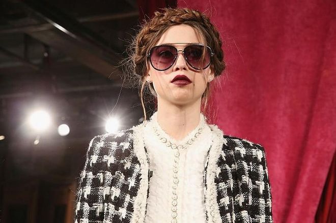 It's all about braids and bold lips at the alice+olivia show. We can't get enough of the braided hair crowns, softened by stray strands strategically pulled out to frame the face. Models were also wearing bold lips in deep burgundy and red, adding the perfect edge to the look, preventing it from looking too ethereal.  Photo: Getty 