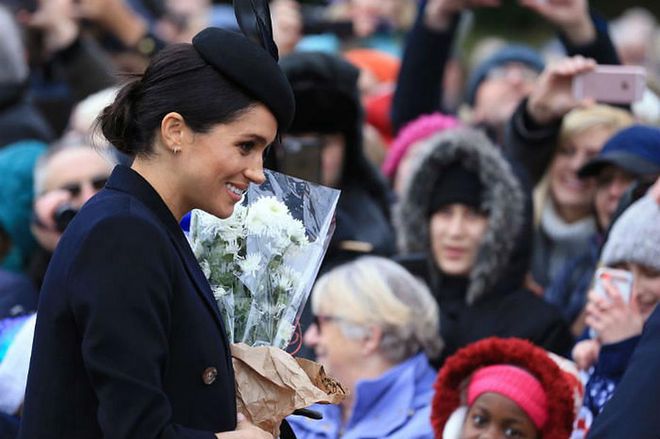 Meghan was gifted a bouquet of flowers by someone in the crowd