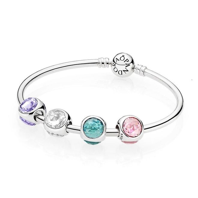 (From left) PANDORA Moments silver bangle, $129, Radiant Droplet charms, $99 each