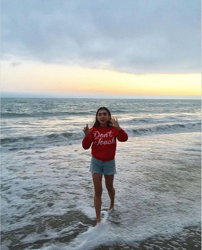 A classic walking on the beach after sundown look: a cheeky sweatshirt and jean cutoffs. <b>Don't Touch Pink Sweater, S$62</b>