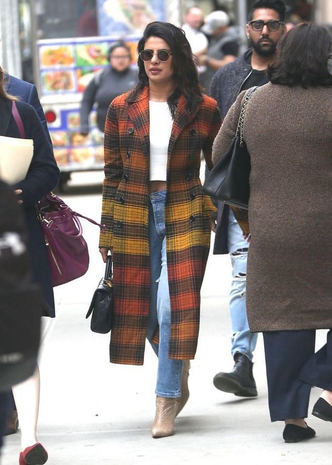 In a orange and yellow checked coat, jeans, and neutral boots while out in New York.

Photo: Splash News