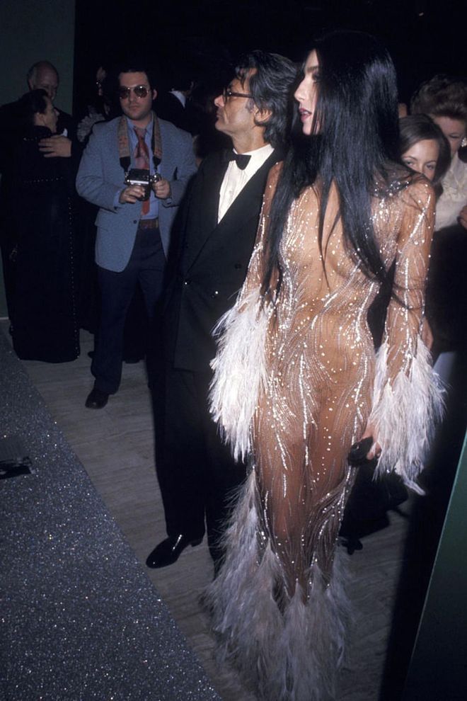 Cher collaborated on many indelible looks with the designer Bob Mackie, but this is one that really got people talking — and wanting a copy for themselves. She first wore this feathery naked dress to the Metropolitan Museum in 1974, then again on the cover of TIME magazine in 1975. "When Cher was on the cover of TIME, in her see-through dress, every tired old broad in Hollywood called asking me for one just like it," Mackie said in 2014. Kim Kardashian paid homage to Cher's dress when she attended the Met Gala four decades later.