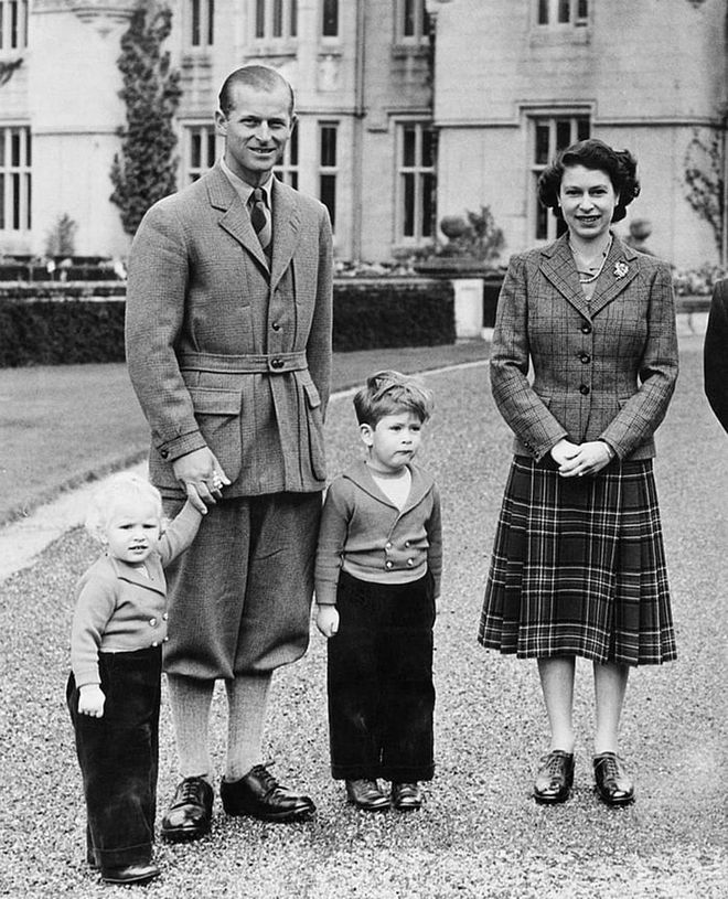 The Queen and Prince Philip with their children Princess Anne, 2, and Prince Charles, 4, on the grounds of Balmoral Castle in Scotland.