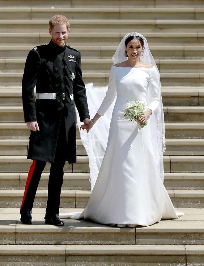 On her big day, Meghan Markle wore a custom Givenchy with an open bateau neckline, designed by Clare Waight Keller, topped off with Queen Mary's diamond bandeau tiara. 