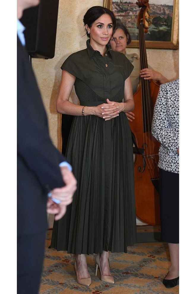 The Duchess wore a gorgeous olive green Brandon Maxwell pleated shirt dress and beige pumps at the Admiralty House for a reception. She dressed up the look by wearing her hair up. 