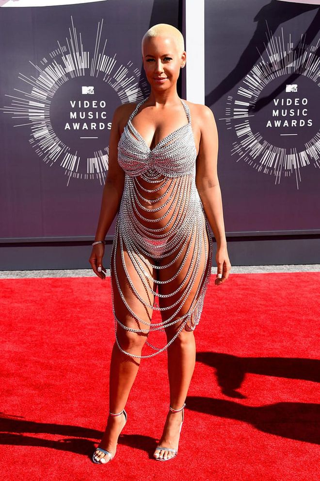 Amber Rose's revealing chain metal dress by Laurel DeWitt, which she wore to the VMAs in 2014, drew comparisons to Rose McGowan's VMAs look from 1998 and yet still managed to shock people. The NYC-based DeWitt is known for her custom creations. She told the Telegraph, "My theory behind it was to create spectacular one of a kind pieces that become so exclusive and can't be found anywhere else, so that the stylists come to me."