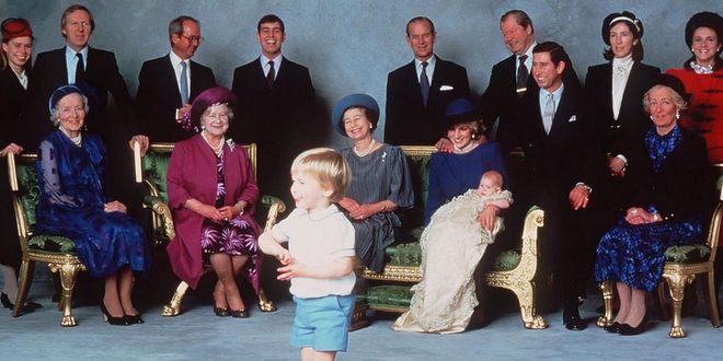 A young Prince William makes the royal family laugh as they pose for photos at Prince Harry's christening.
Photo: Getty
