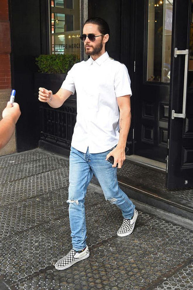 Jared Leto in a white button-down, ripped jeans and Vans while promoting the movie in New York. Photo: Getty