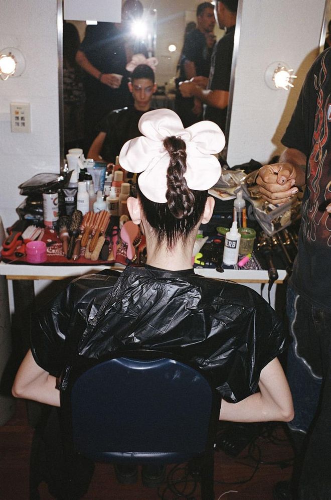 A model wearing Sandy Liang’s flower power scrunchie backstage at her spring 2023 show. (Photo: Phoenix Johnson)
