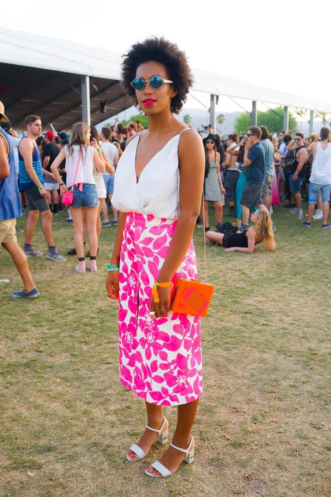 The icon goes fashionably casual in a J.Crew Spring hot pink floral hibiscus printed skirt and white sandals
