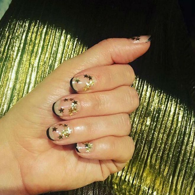 Love this look! Apply a clear top coat, paint a thin black line at the tip, then cluster gold stars randomly around each nail.
@valleynyc 