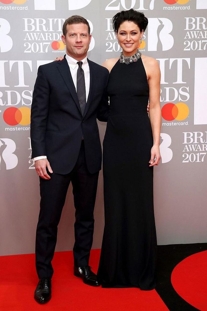 The evening's hosts; Dermot O'Leary - in a classic black suit - and Emma Willis, in an Alexander McQueen gown. Photo: Getty