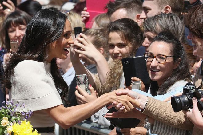 The Duchess greets the crowds gathered for a royal glimpse. Photo: Getty