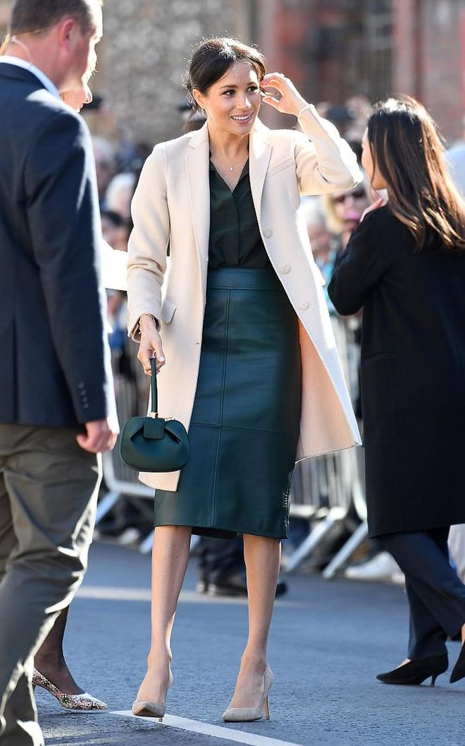 Meghan visited her namesake of Sussex for the first time in a forest green silk shirt and leather skirt combo from & Other Stories and Hugo Boss respectively.  Her stunning beige cashmere coat is from Emporio Armani and she accessorized with the fashion editor favourite, the Gabriela Hearst demi satin tote in emerald green. Finishing off the look with nude Stuart Weitzman pumps, it's understated yet chic. Love! 